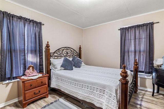 bedroom with crown molding and hardwood / wood-style flooring