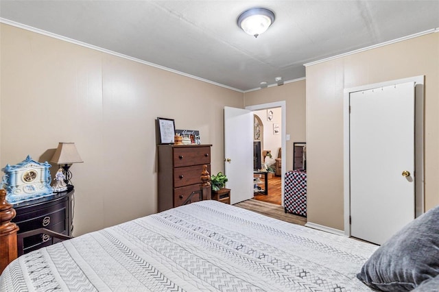 bedroom featuring crown molding and light wood-type flooring