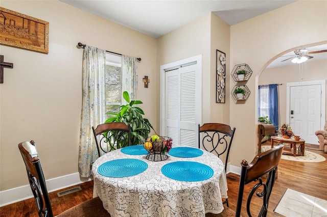 dining room with dark hardwood / wood-style floors and ceiling fan