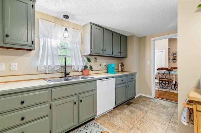 kitchen with sink, a textured ceiling, dishwasher, and pendant lighting