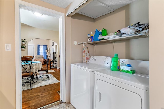 washroom with light hardwood / wood-style flooring and washing machine and clothes dryer