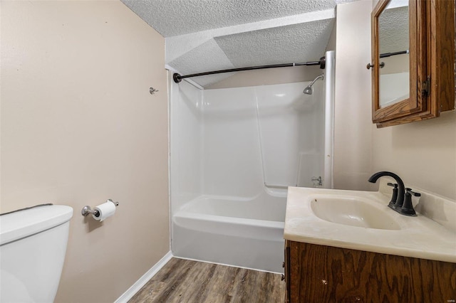 full bath with shower / washtub combination, a textured ceiling, toilet, and wood finished floors