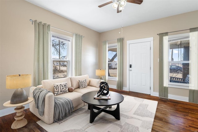 sitting room with ceiling fan, visible vents, baseboards, and wood finished floors