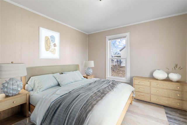 bedroom with light wood-type flooring and crown molding