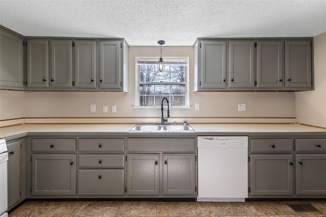 kitchen with light countertops, visible vents, gray cabinetry, a sink, and dishwasher