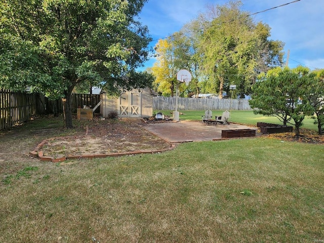 view of yard featuring a shed and a fire pit