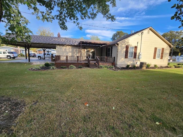 ranch-style house with central air condition unit, a carport, a deck, and a front lawn