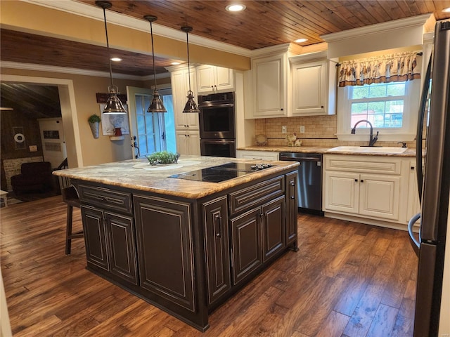 kitchen with a kitchen island, a breakfast bar area, dark wood-type flooring, sink, and appliances with stainless steel finishes