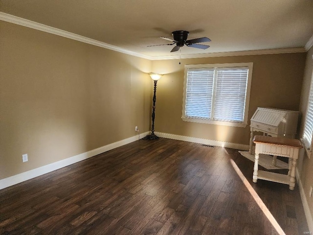 empty room featuring ornamental molding, dark hardwood / wood-style floors, and ceiling fan