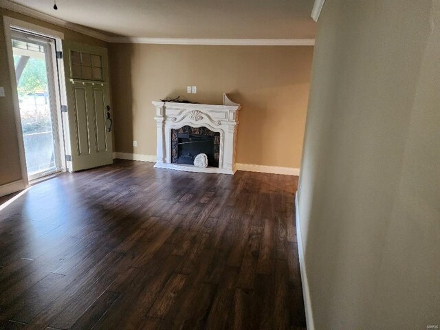 unfurnished living room with ornamental molding and dark hardwood / wood-style floors