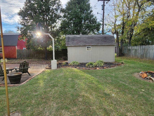 view of yard with a storage shed and a fire pit