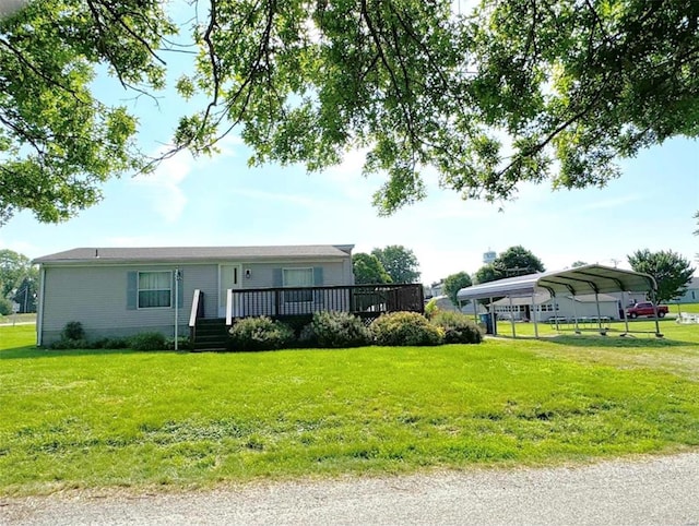 view of front of home with a carport and a front lawn