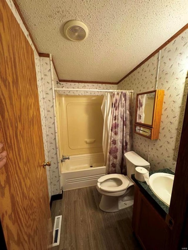 full bathroom with a textured ceiling, shower / bath combo, toilet, vanity, and hardwood / wood-style flooring