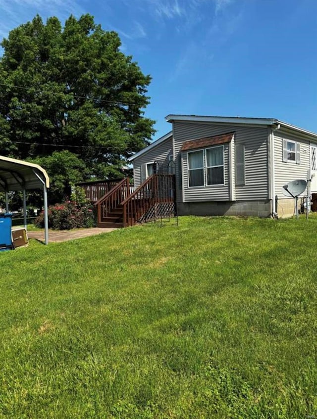 exterior space featuring a lawn and a carport