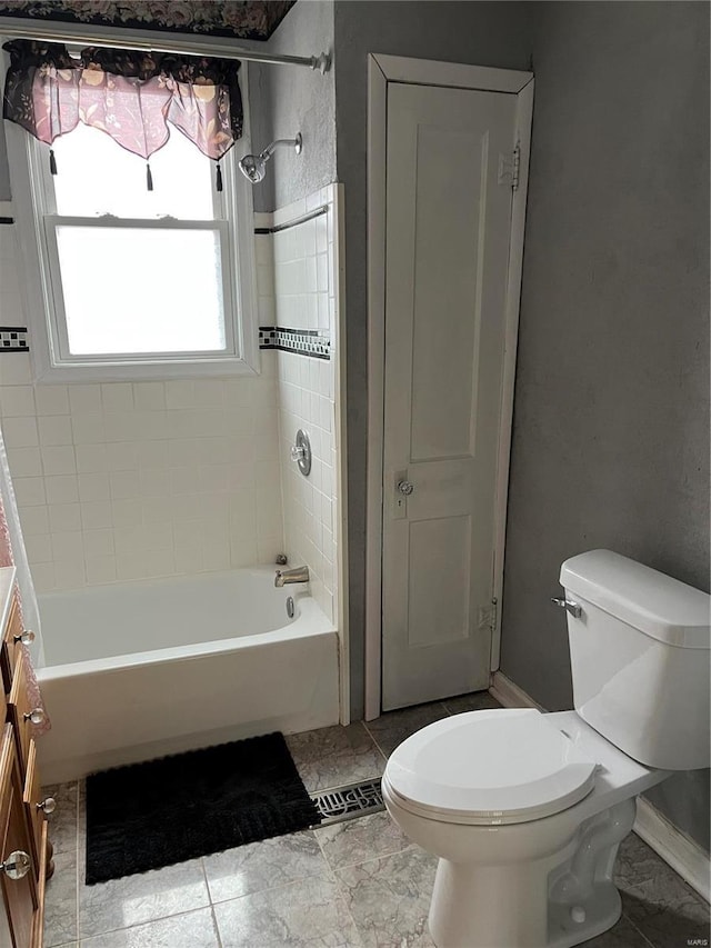 full bathroom with vanity, toilet, and tiled shower / bath