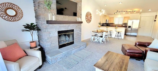 living room with track lighting and a fireplace