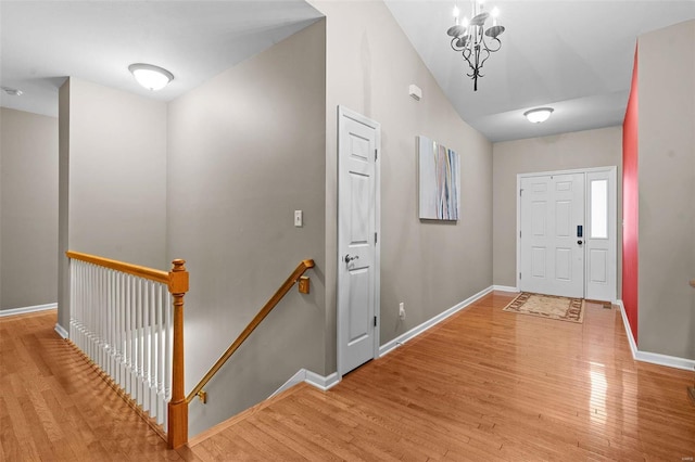 foyer featuring an inviting chandelier and light hardwood / wood-style flooring