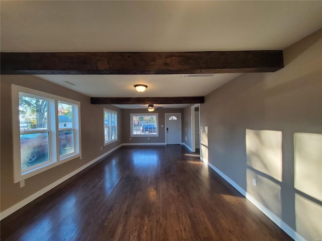 interior space featuring dark hardwood / wood-style floors, beam ceiling, ceiling fan, and a wealth of natural light