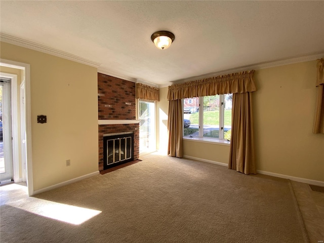 unfurnished living room with a textured ceiling, ornamental molding, carpet floors, and a fireplace