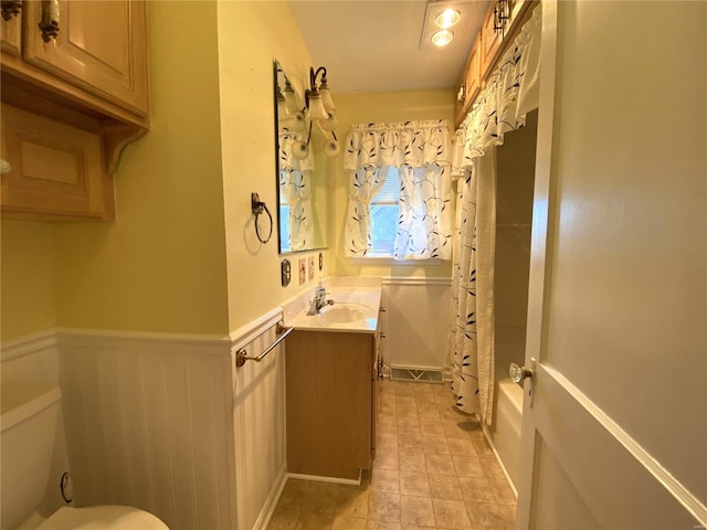 full bathroom with toilet, vanity, and shower / tub combo