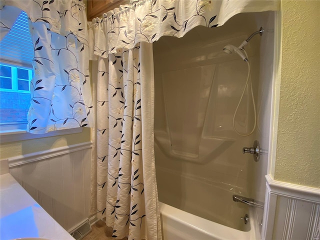 bathroom featuring shower / bathtub combination with curtain