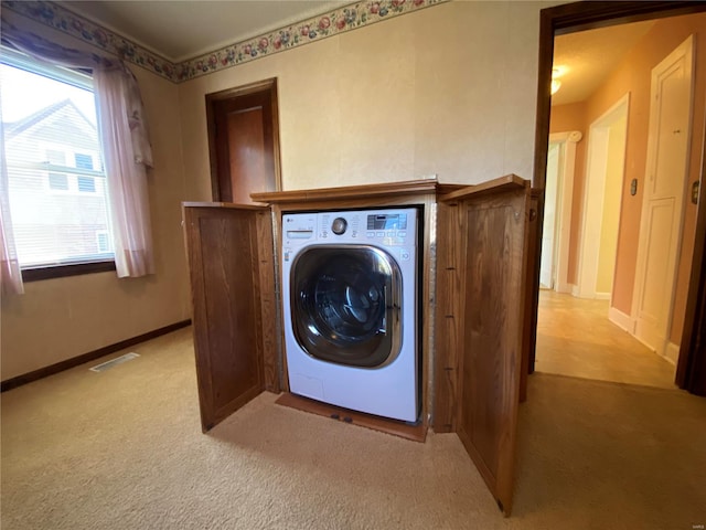 laundry room featuring washer / dryer and light carpet