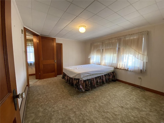 bedroom featuring ornamental molding and carpet