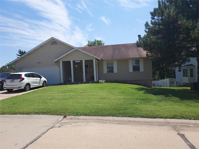 ranch-style home featuring a garage and a front lawn