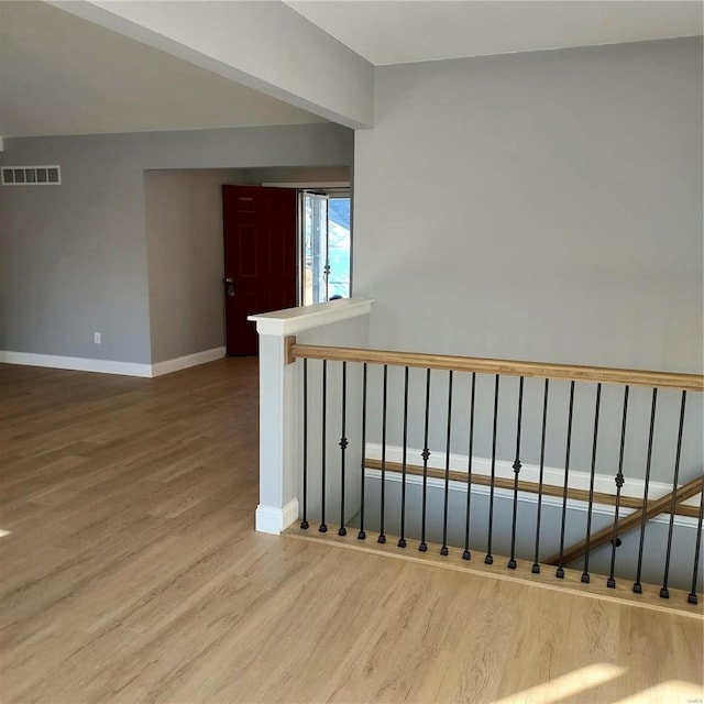 stairway featuring wood-type flooring