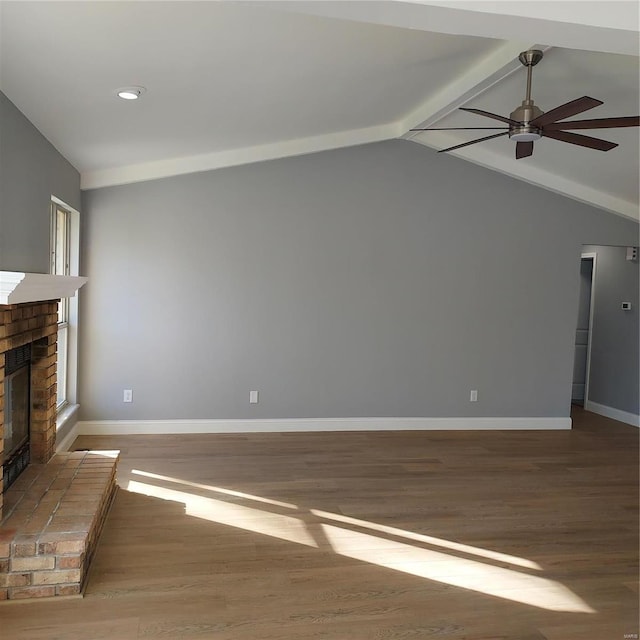 unfurnished living room with a fireplace, hardwood / wood-style flooring, vaulted ceiling, and ceiling fan