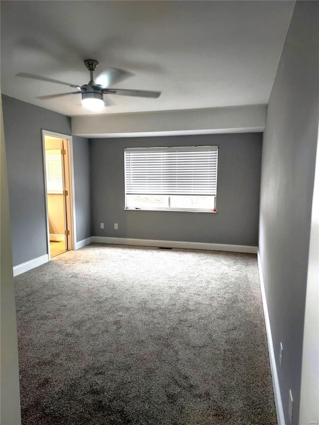 empty room featuring carpet and ceiling fan