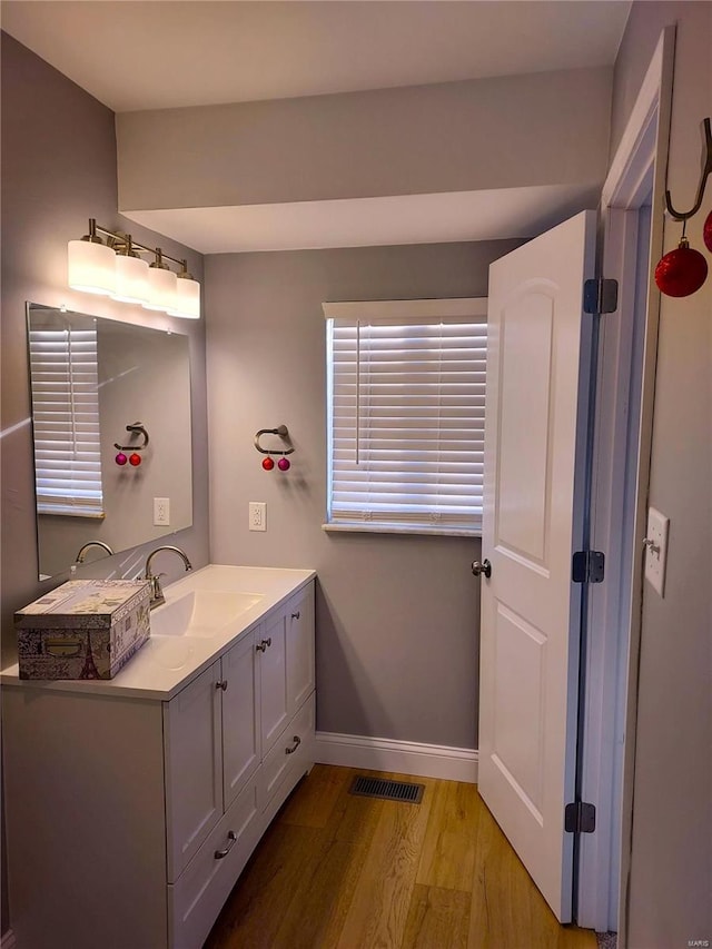 bathroom with vanity and wood-type flooring