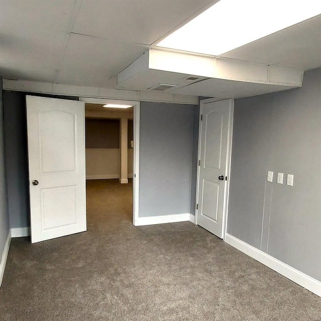 basement with dark colored carpet