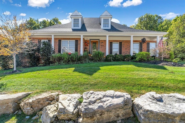 cape cod-style house with a front yard