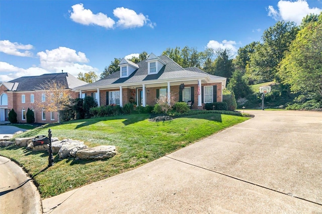 view of front of house with a porch and a front yard