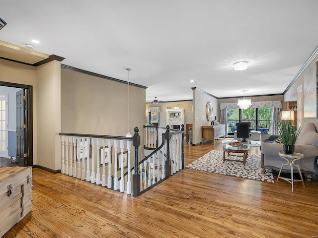 interior space with ornamental molding, light hardwood / wood-style flooring, and an inviting chandelier