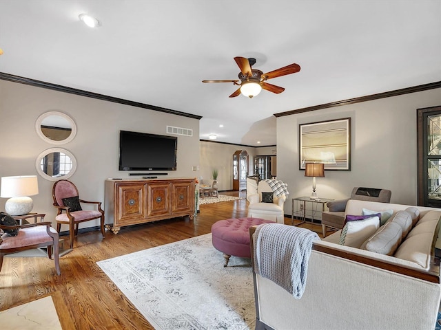 living room with crown molding, hardwood / wood-style flooring, and plenty of natural light