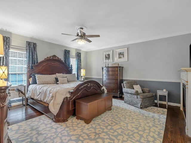 bedroom with dark hardwood / wood-style flooring, ornamental molding, multiple windows, and ceiling fan