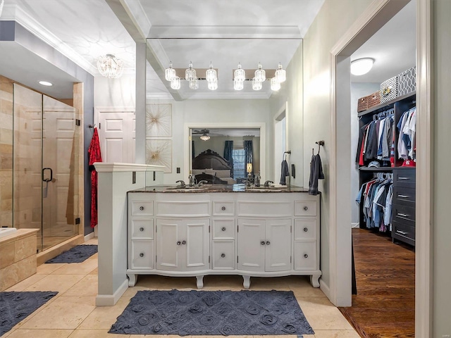 bathroom featuring vanity, an enclosed shower, ornamental molding, and tile patterned floors