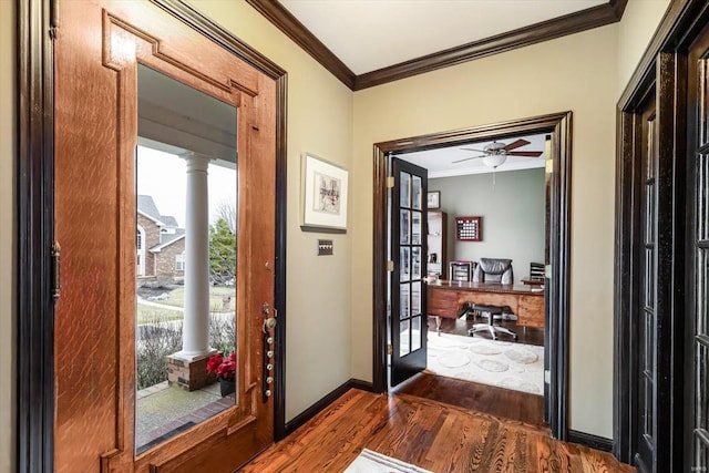 interior space with crown molding, dark wood-type flooring, decorative columns, and ceiling fan