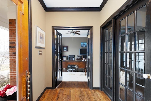 entryway featuring dark hardwood / wood-style flooring, crown molding, french doors, and ceiling fan