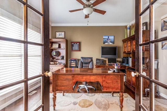 office with ornamental molding, light hardwood / wood-style flooring, ceiling fan, and french doors