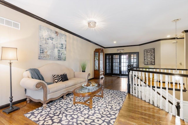 living room featuring hardwood / wood-style flooring, ornamental molding, and french doors