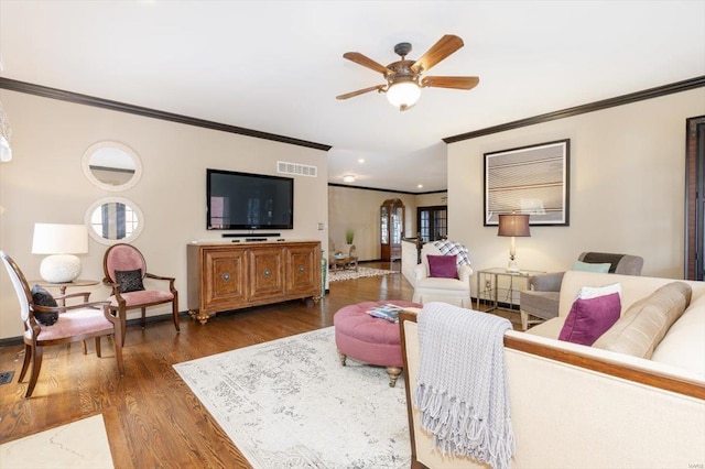 living room featuring crown molding, dark hardwood / wood-style floors, and ceiling fan