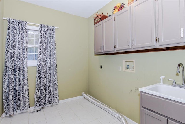 laundry area with hookup for a washing machine, sink, hookup for an electric dryer, and cabinets