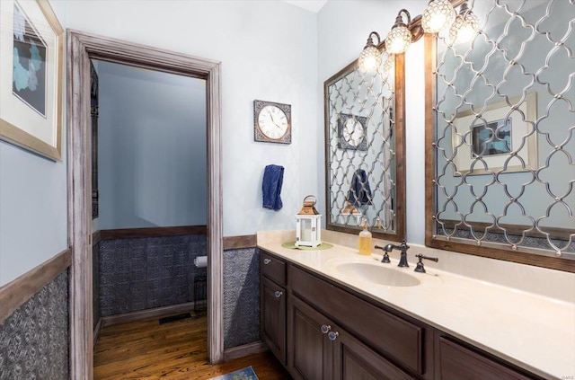 bathroom with hardwood / wood-style flooring and vanity