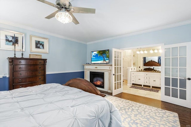 bedroom featuring ornamental molding, hardwood / wood-style floors, and french doors