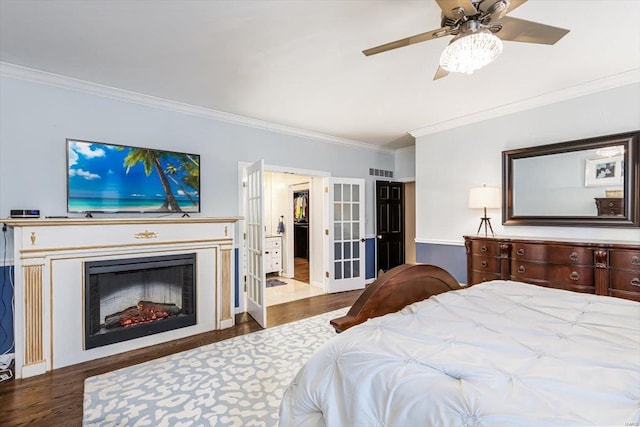 bedroom with crown molding, dark wood-type flooring, and ceiling fan