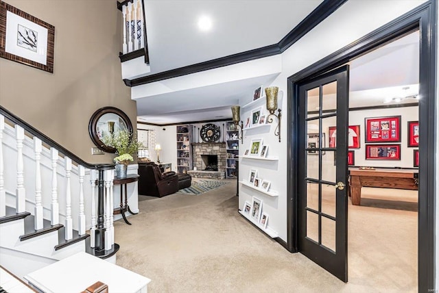 interior space featuring ornamental molding, carpet, and a fireplace