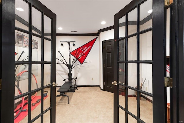 carpeted home office featuring french doors and crown molding